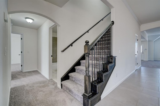 4116 NW 155th St, Edmond, OK 73013 - staircase featuring arched walkways, baseboards, crown molding, and tile patterned floors
