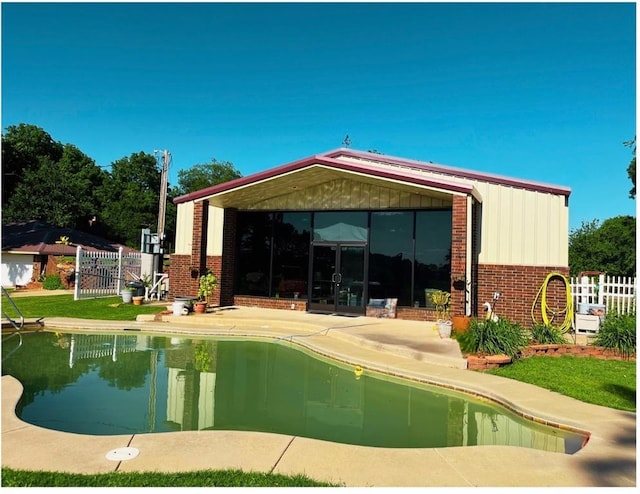 12301 US Highway 77, Lexington, OK 73051 - rear view of house with an outdoor pool, brick siding, and a patio