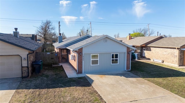 1422 SW 96th St, Oklahoma City, OK 73159 - view of front of property with driveway, brick siding, and a chimney