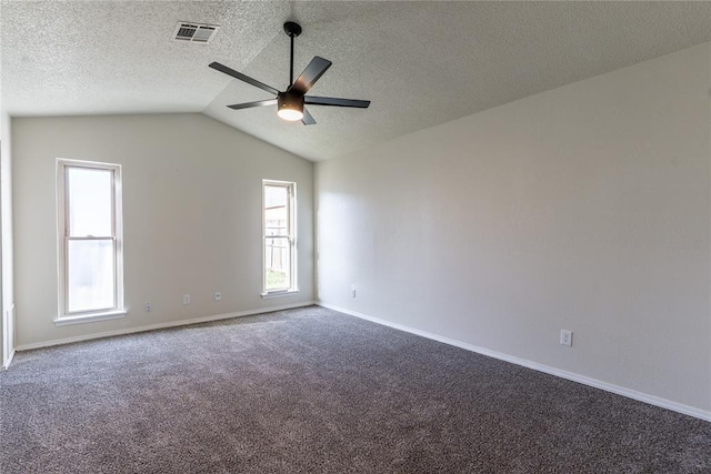1422 SW 96th St, Oklahoma City, OK 73159 - empty room with a ceiling fan, carpet, vaulted ceiling, a textured ceiling, and baseboards