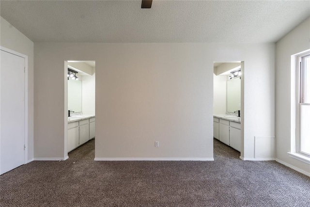 1422 SW 96th St, Oklahoma City, OK 73159 - unfurnished bedroom featuring dark carpet, a textured ceiling, ensuite bath, and baseboards