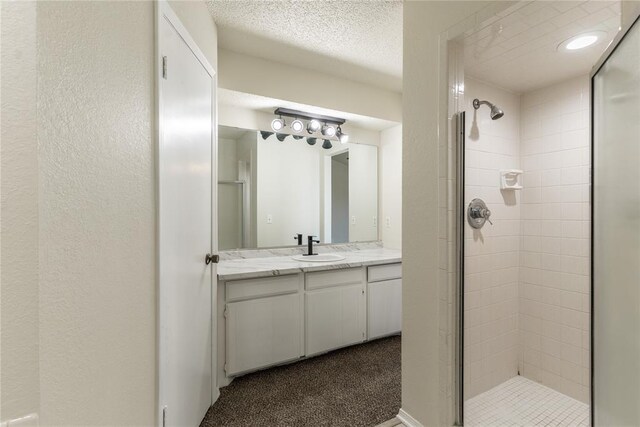 1422 SW 96th St, Oklahoma City, OK 73159 - full bathroom featuring a stall shower, vanity, a textured ceiling, and a textured wall