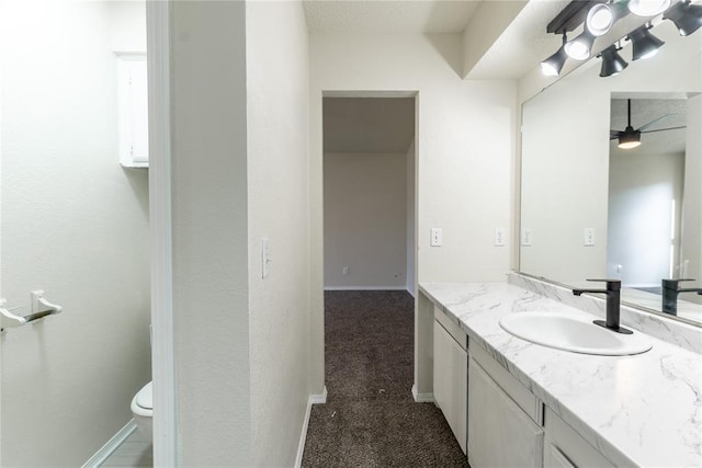 1422 SW 96th St, Oklahoma City, OK 73159 - bathroom with vanity, toilet, a ceiling fan, and baseboards