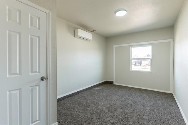 1422 SW 96th St, Oklahoma City, OK 73159 - empty room featuring a wall mounted AC, dark carpet, and baseboards