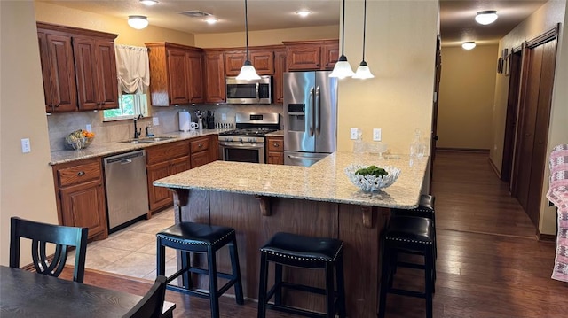 339770 E 1040th Cir, Meeker, OK 74855 - kitchen featuring appliances with stainless steel finishes, a sink, a peninsula, and backsplash