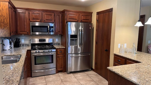 339770 E 1040th Cir, Meeker, OK 74855 - kitchen featuring appliances with stainless steel finishes, light stone countertops, tasteful backsplash, and light tile patterned flooring