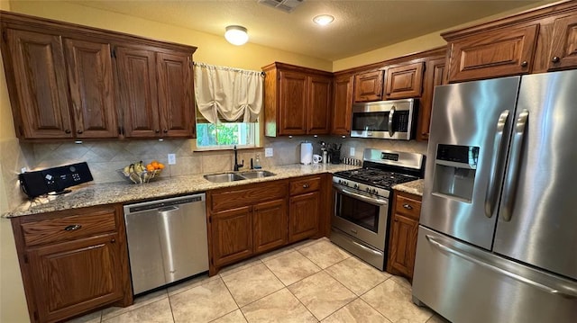 339770 E 1040th Cir, Meeker, OK 74855 - kitchen featuring stainless steel appliances, a sink, backsplash, and light stone counters