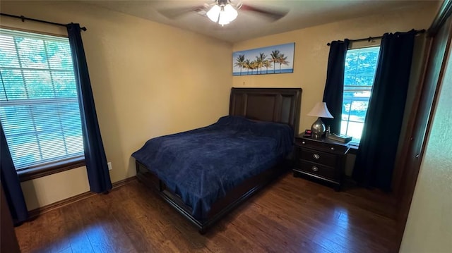 339770 E 1040th Cir, Meeker, OK 74855 - bedroom featuring dark wood-style floors, multiple windows, and ceiling fan