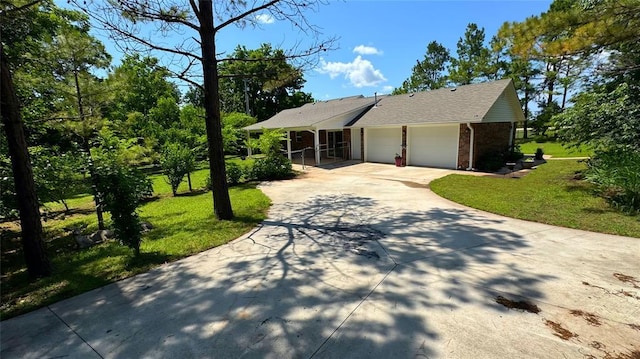 339770 E 1040th Cir, Meeker, OK 74855 - view of front facade featuring driveway, a garage, brick siding, and a front yard
