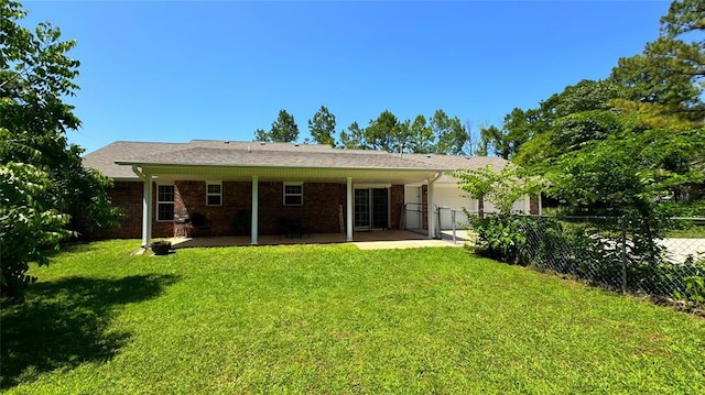 339770 E 1040th Cir, Meeker, OK 74855 - back of house featuring a garage, a patio area, and brick siding