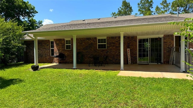 339770 E 1040th Cir, Meeker, OK 74855 - back of house featuring a patio, a lawn, brick siding, and roof with shingles