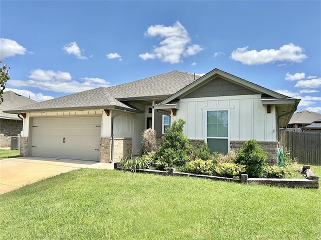 9632 Ashford Dr, Yukon, OK 73099 - single story home with a garage, concrete driveway, roof with shingles, board and batten siding, and brick siding