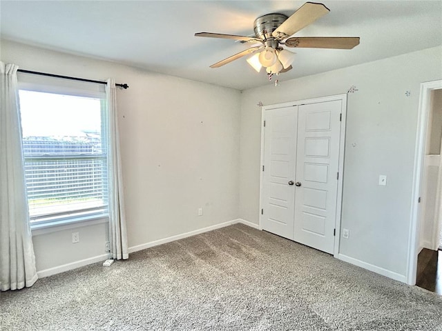 9632 Ashford Dr, Yukon, OK 73099 - unfurnished bedroom featuring multiple windows, carpet flooring, a closet, and a ceiling fan