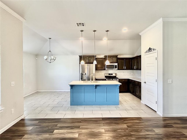 9632 Ashford Dr, Yukon, OK 73099 - kitchen with stainless steel appliances, lofted ceiling, a chandelier, tasteful backsplash, and dark brown cabinetry
