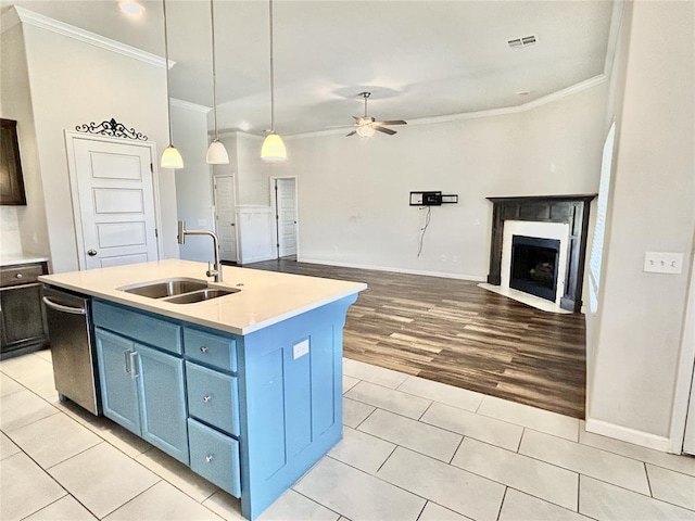 9632 Ashford Dr, Yukon, OK 73099 - kitchen with ornamental molding, blue cabinets, ceiling fan, stainless steel dishwasher, and light countertops