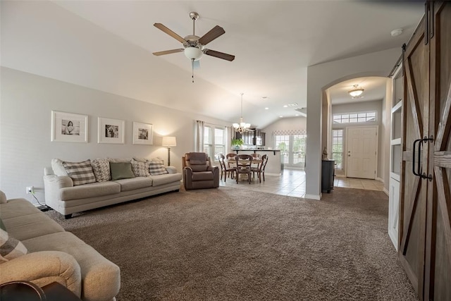 19005 Valencia Park Dr, Edmond, OK 73012 - living area featuring ceiling fan, vaulted ceiling, light carpet, arched walkways, and light tile patterned flooring