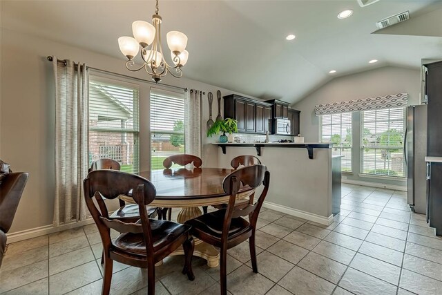 19005 Valencia Park Dr, Edmond, OK 73012 - dining area featuring a chandelier, lofted ceiling, recessed lighting, light tile patterned floors, and baseboards