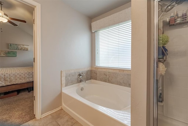 19005 Valencia Park Dr, Edmond, OK 73012 - bathroom with ensuite bathroom, a garden tub, a ceiling fan, tile patterned floors, and baseboards