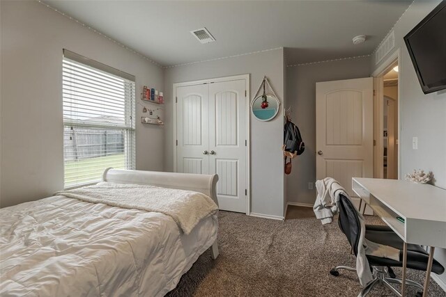 19005 Valencia Park Dr, Edmond, OK 73012 - bedroom featuring a closet, carpet floors, baseboards, and a desk