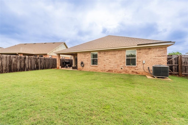 19005 Valencia Park Dr, Edmond, OK 73012 - rear view of property featuring central AC, brick siding, a shingled roof, and a patio area