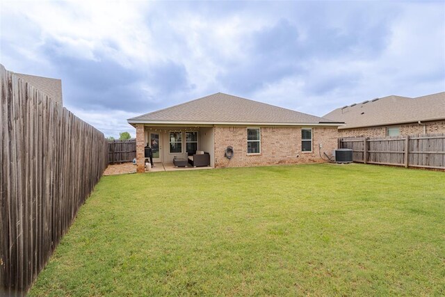 19005 Valencia Park Dr, Edmond, OK 73012 - back of house with central AC, brick siding, and a patio area