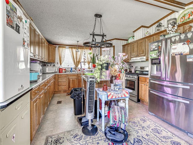 19519 N 2730th Rd, Kingfisher, OK 73750 - kitchen featuring stainless steel appliances, ornamental molding, under cabinet range hood, a textured ceiling, and a chandelier