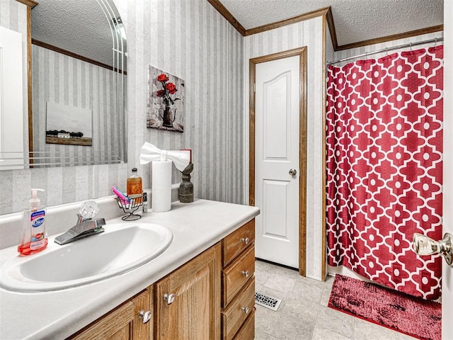 19519 N 2730th Rd, Kingfisher, OK 73750 - bathroom featuring ornamental molding, a textured ceiling, vanity, wallpapered walls, and tile patterned flooring