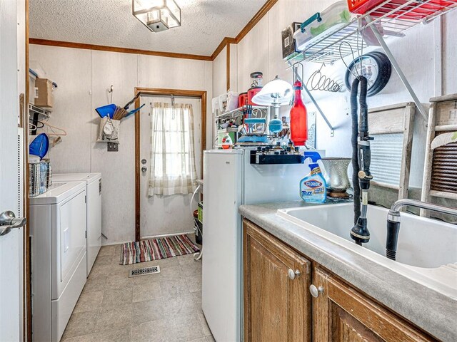 19519 N 2730th Rd, Kingfisher, OK 73750 - laundry room with crown molding, washing machine and clothes dryer, a textured ceiling, and wood walls