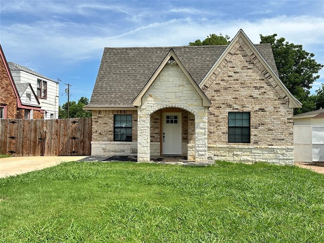 327 SW Grand Blvd, Oklahoma City, OK 73109 - view of front of house featuring stone siding and a shingled roof