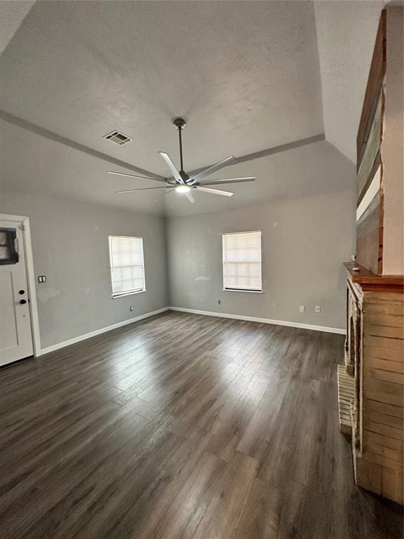 327 SW Grand Blvd, Oklahoma City, OK 73109 - unfurnished living room with a ceiling fan, dark wood finished floors, a brick fireplace, and a textured ceiling