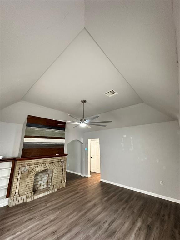 327 SW Grand Blvd, Oklahoma City, OK 73109 - unfurnished living room with lofted ceiling, a ceiling fan, wood finished floors, and a brick fireplace