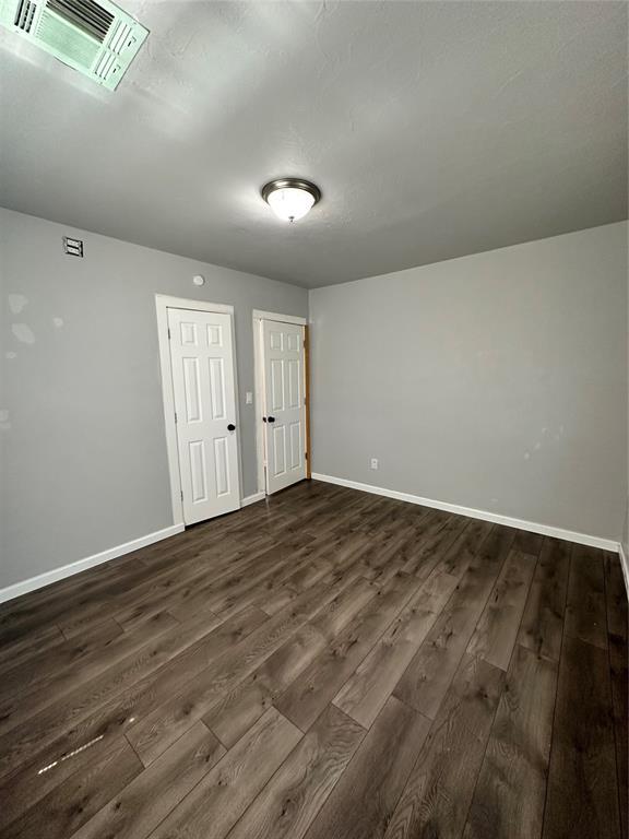 327 SW Grand Blvd, Oklahoma City, OK 73109 - empty room with dark wood-style flooring