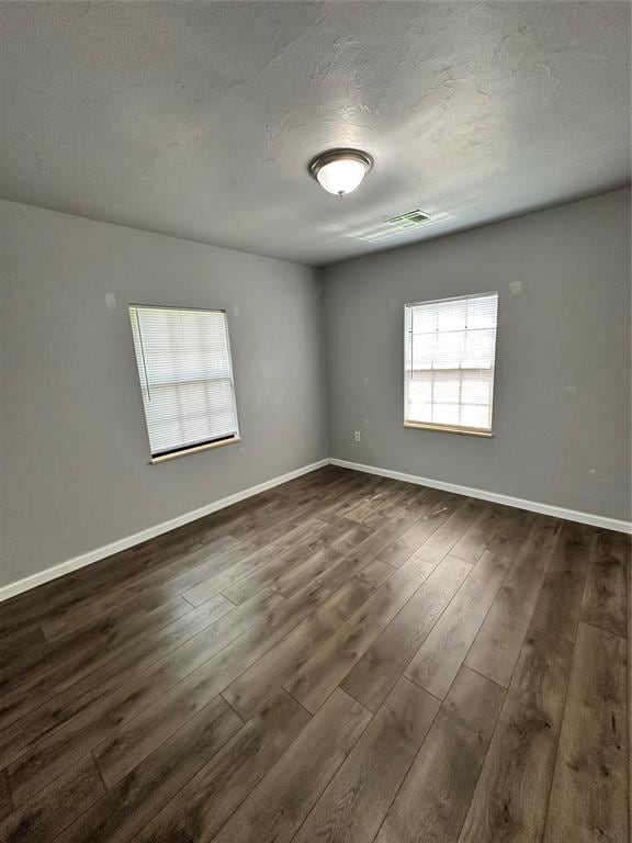 327 SW Grand Blvd, Oklahoma City, OK 73109 - unfurnished room featuring dark wood-style floors and a textured ceiling