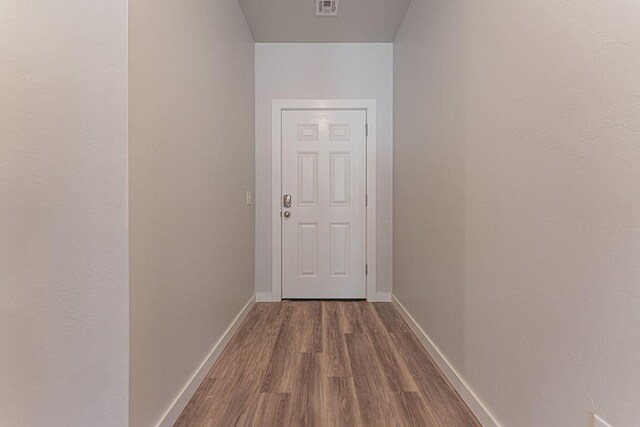 741 Stella Trl, Guthrie, OK 73044 - doorway with dark wood-style floors and baseboards