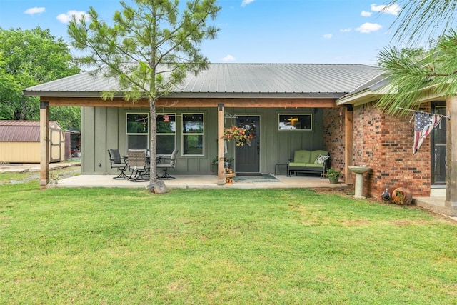 26114 State Highway 19, Cyril, OK 73029 - back of house featuring board and batten siding, a yard, and metal roof