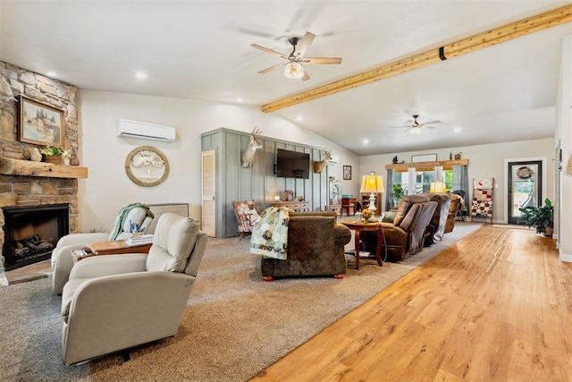 26114 State Highway 19, Cyril, OK 73029 - living room featuring a ceiling fan, a wall unit AC, wood finished floors, and a stone fireplace