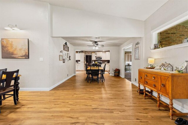 26114 State Highway 19, Cyril, OK 73029 - dining room featuring light wood finished floors, a ceiling fan, and baseboards