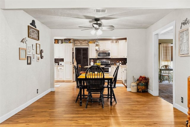 26114 State Highway 19, Cyril, OK 73029 - dining room with a ceiling fan, baseboards, and light wood-style flooring