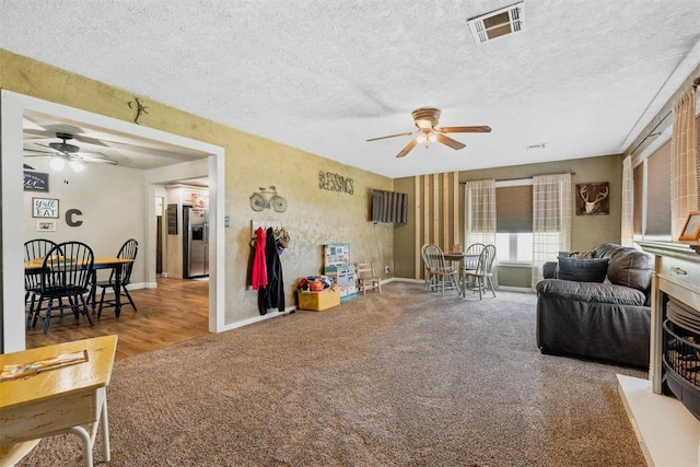 26114 State Highway 19, Cyril, OK 73029 - carpeted living room with ceiling fan, baseboards, and a textured ceiling