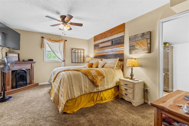 26114 State Highway 19, Cyril, OK 73029 - carpeted bedroom featuring a fireplace with raised hearth, a ceiling fan, and baseboards