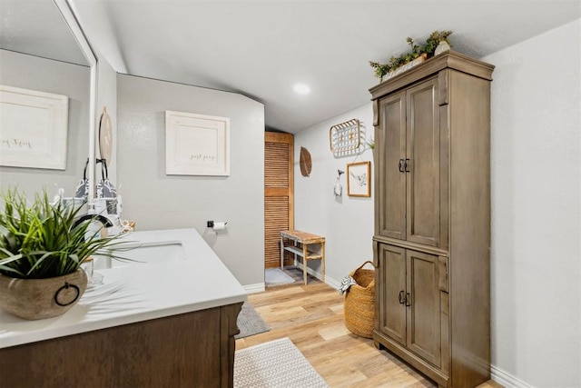 26114 State Highway 19, Cyril, OK 73029 - bathroom featuring baseboards, wood finished floors, vanity, and recessed lighting