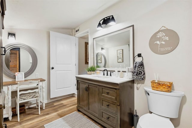 26114 State Highway 19, Cyril, OK 73029 - bathroom featuring vanity, wood finished floors, and toilet