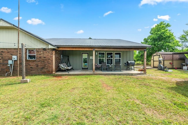 26114 State Highway 19, Cyril, OK 73029 - rear view of house featuring a patio area, a lawn, board and batten siding, and brick siding