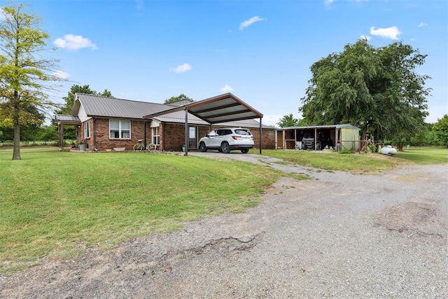 26114 State Highway 19, Cyril, OK 73029 - view of front of property featuring driveway, a carport, a front yard, metal roof, and brick siding