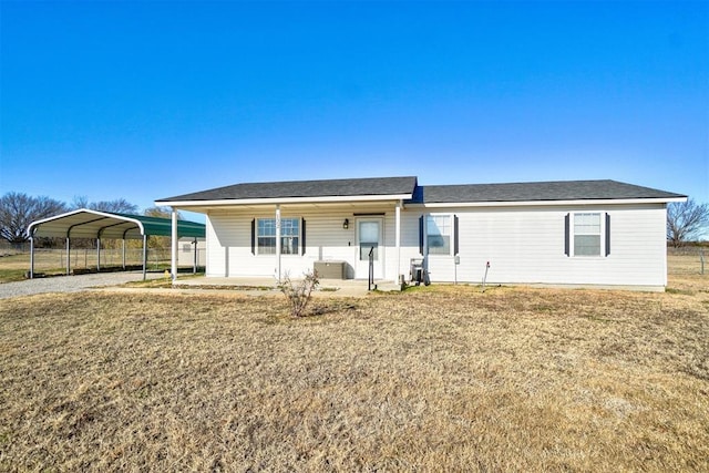 122 Cotton Tail Dr, Shawnee, OK 74804 - view of front of house featuring a front lawn, gravel driveway, and a carport
