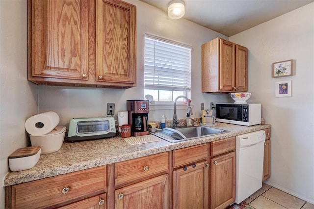 122 Cotton Tail Dr, Shawnee, OK 74804 - kitchen featuring white dishwasher, light countertops, light tile patterned floors, and brown cabinetry