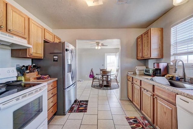 122 Cotton Tail Dr, Shawnee, OK 74804 - kitchen with white appliances, under cabinet range hood, light countertops, light tile patterned floors, and ceiling fan