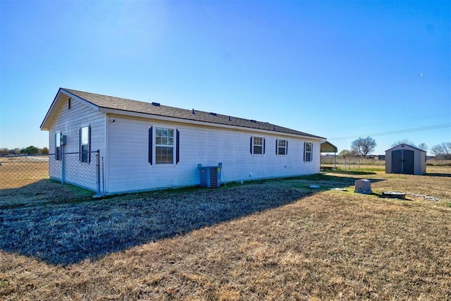122 Cotton Tail Dr, Shawnee, OK 74804 - rear view of property featuring a storage unit