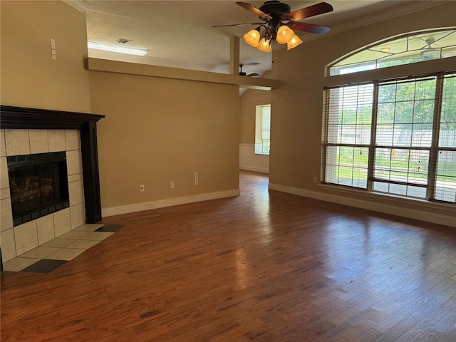 1617 Briarcreek, Norman, OK 73071 - unfurnished living room featuring baseboards, wood finished floors, ceiling fan, a fireplace, and ornamental molding