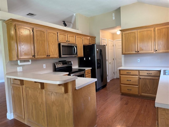 1617 Briarcreek, Norman, OK 73071 - kitchen with appliances with stainless steel finishes, lofted ceiling, a peninsula, dark wood-style floors, and light countertops
